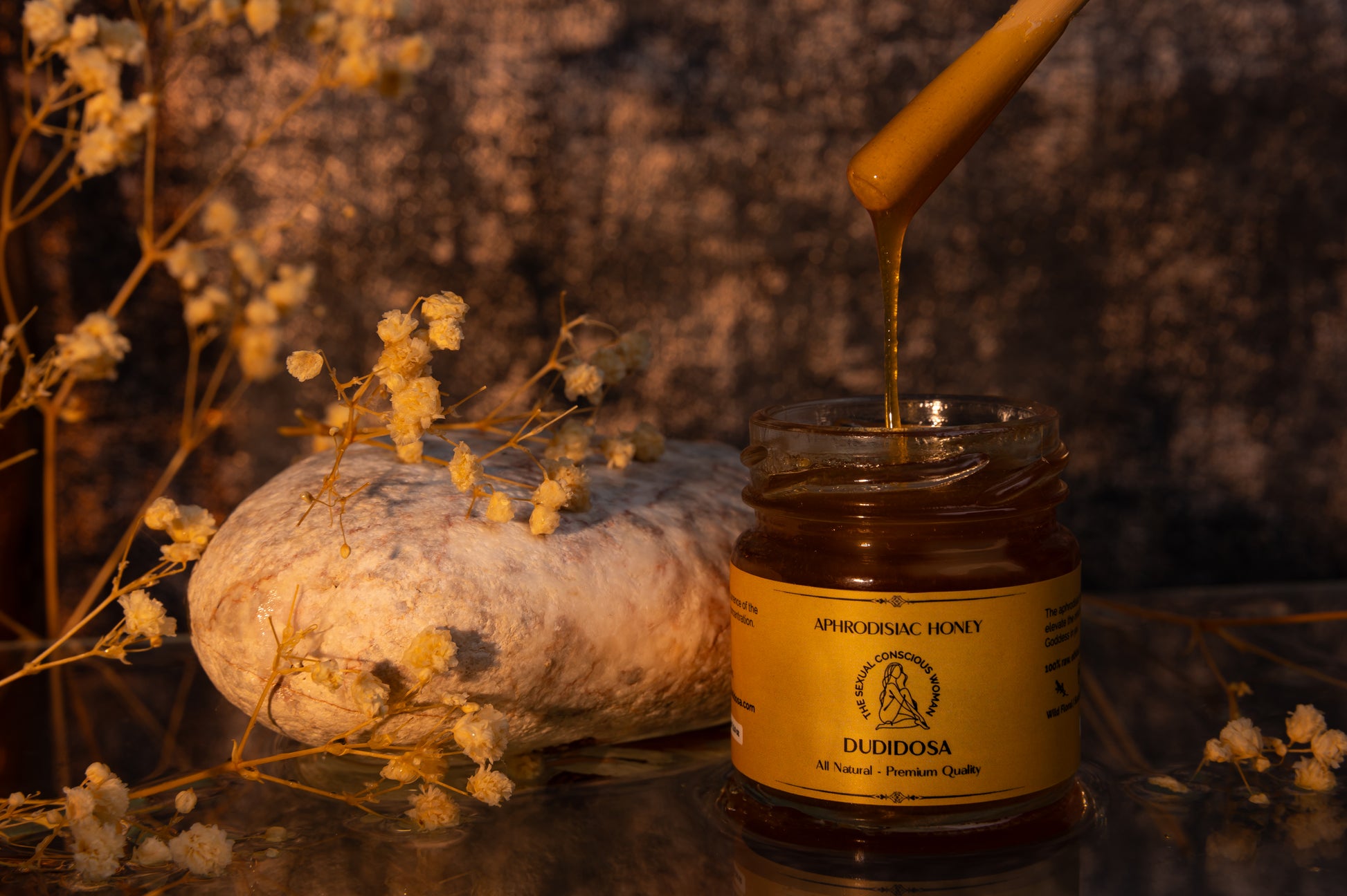 Elegant DUDIDOSA Aphrodisiac Honey jar and packaging with golden honey dripping from a spoon — a natural sensual blend that awakens desire and relaxation.