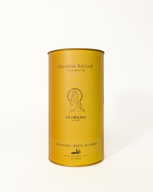 Golden cylindrical tin of DUDIDOSA Damiana Tea Leaf with minimalist gold detailing and logo. A natural aphrodisiac herbal tea made from damiana leaves, known to calm the mind, lift mood, and enhance sensual connection