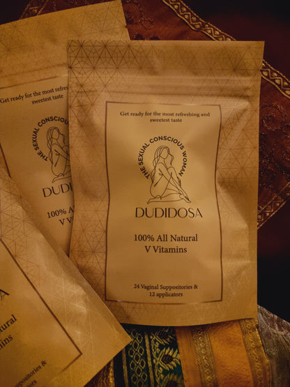 DUDIDOSA V-Vitamins pouches lying on colorful silk fabric. The warm, rich setting gives a cozy and elegant feel — highlighting the product’s natural, gentle formula that helps balance pH, improve freshness, and subtly sweeten taste.