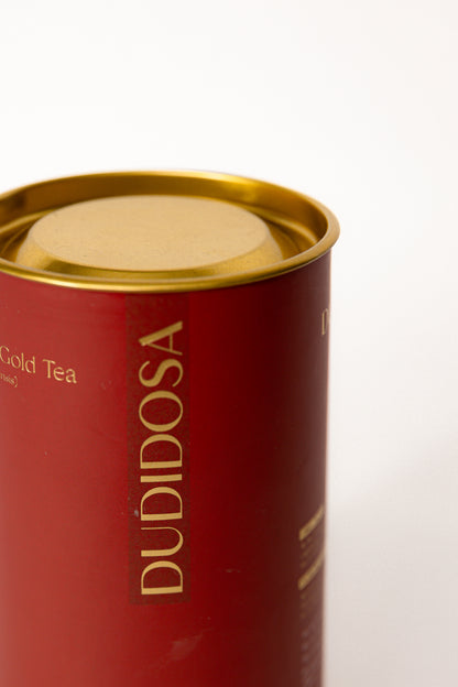 side of dudidosa Red Ginseng & Himalayan Gold Tea's packaging - red and gold tin with golden letters has a elegant look
